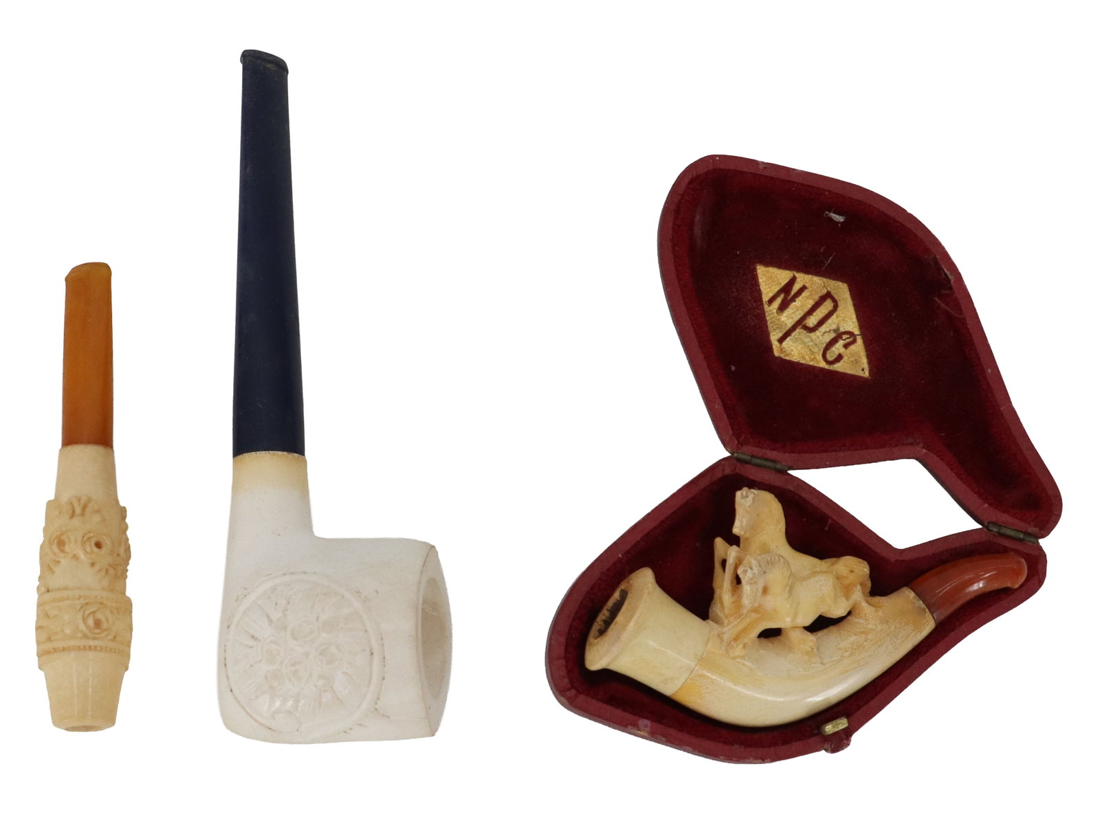 (3) Vintage Meerschaum Pipes: (3) Vintage Meerschaum Pipes. Includes a curved one with horse decoration in a shaped case marked "NPC" on the inside, a short straight one, and a traditionally shaped one that is marke