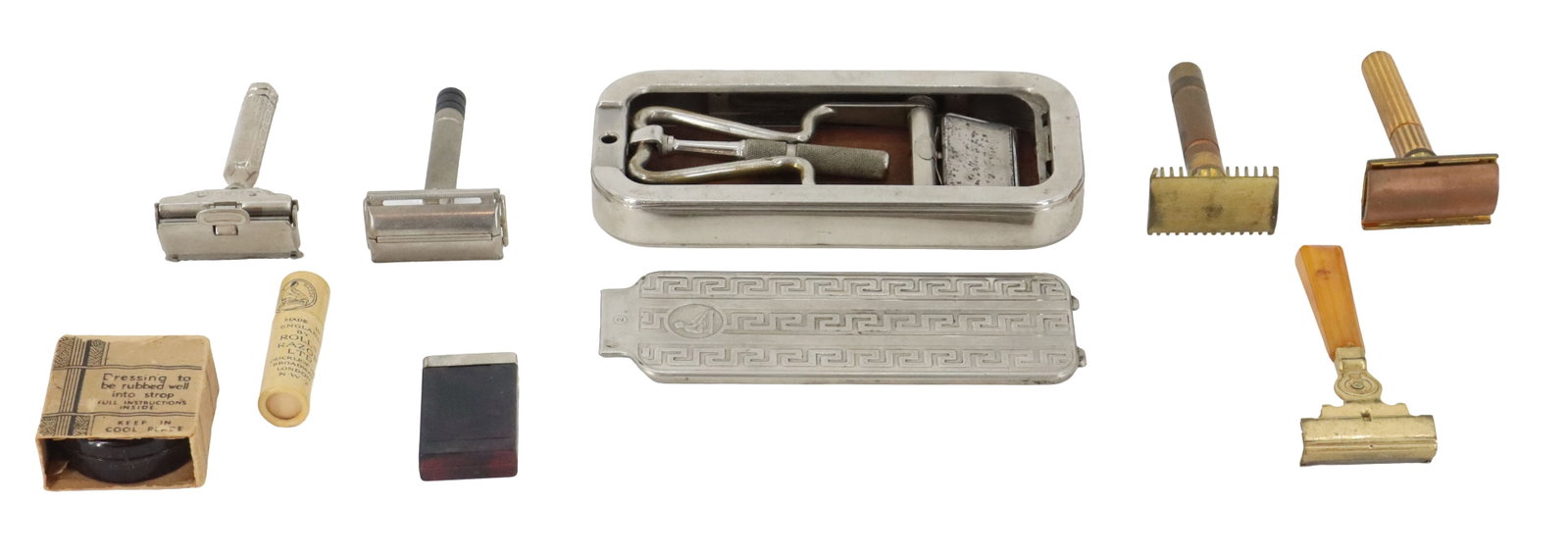 Assortment of Antique Shaving Equipment: Assortment of Antique Shaving Equipment. Highlighted by a cased Rolls Razor system complete with its signature Greek key pattern lid. The lot also includes five various safety razors in silver, brass,
