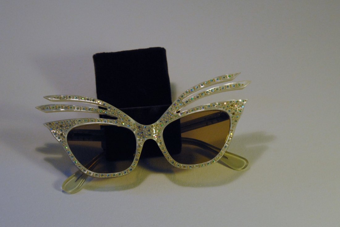 Elaborate White and Crystal Sunglasses: White Bakelite cat eye sunglasses with crystals decorating the frames.