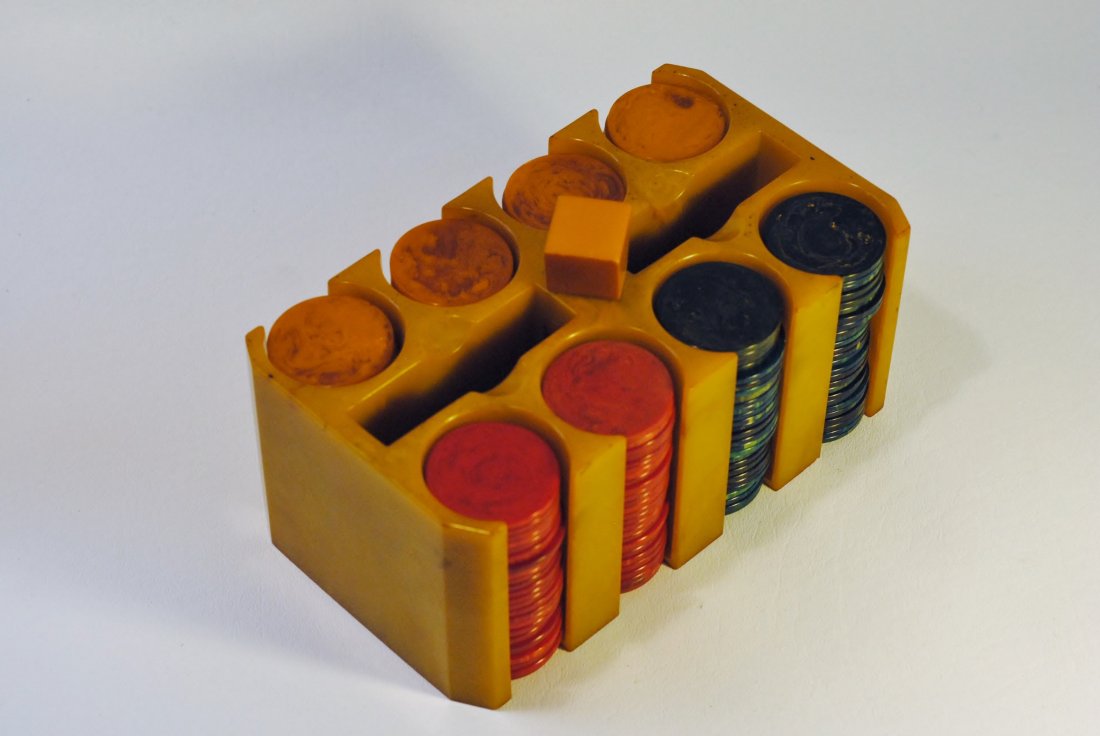 Bakelite Poker Chip Tray: Bakelite poker tray in amber Bakelite construction, with four sets of marbleized amber Bakelite poker chips, two sets of red marbleized Bakelite poker chips, and two dark green and yellow marbleized B