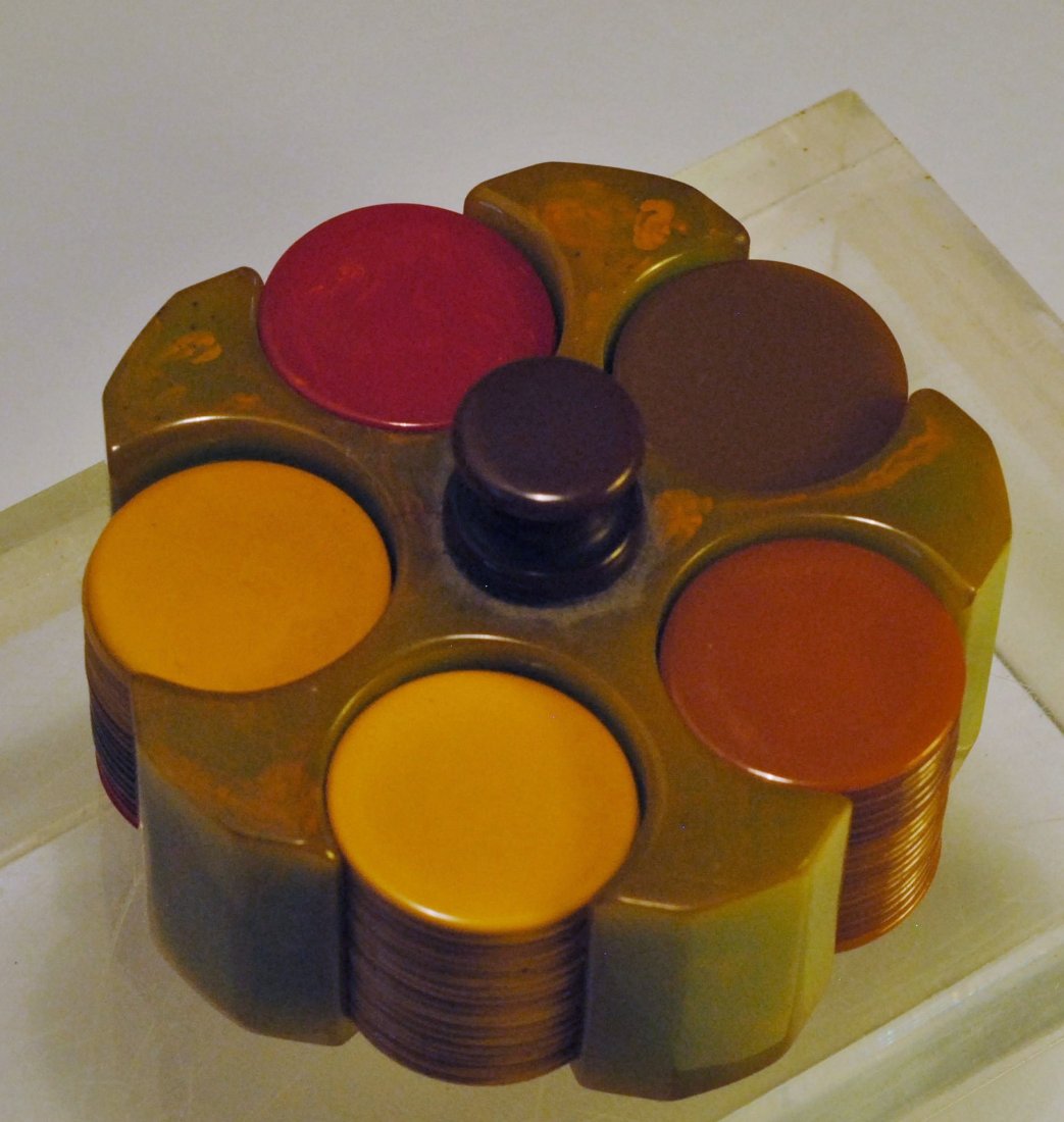 Bakelite Poker Chip Set: Light olive green colored Bakelite poker tray with brown colored Bakelite handle, and having Bakelite poker chips in red, amber, dark olive green, and yellow colors.Diameter 3.5 in