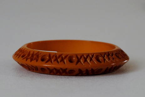 Amber Bakelite Bangle with "XO" Design: Amber color bakelite bangle , with carved "x" design and circles interspersed