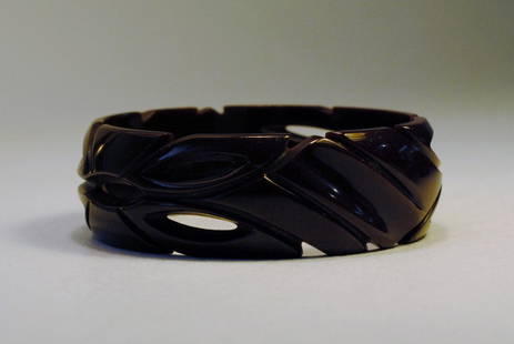 Brown Bakelite Bangle w/ Intricate Carvings: Brown Bakelite bangle with intricate carvings in a leaf like motif