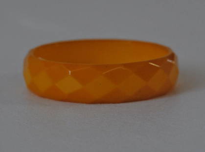 Yellow Bakelite Bangle w/ Diamond Motif: Yellow Bakelite bangle with carved diamond motif