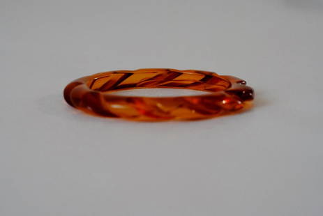 Translucent Amber Bakelite Bangle: Translucent amber color bakelite bangle in a slim form with a twisted carved design