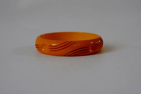 Yellow/Amber Bakelite bangle w/Carved Motif: Yellow/amber bakelite bangle with carved circular and line motif