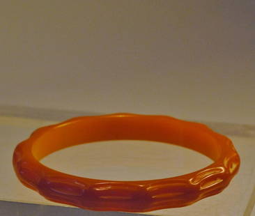 Dark Amber Bakelite Bangle w/ Carved Motif: Darker amber color bakelite bangle in a slim design with carved motif.