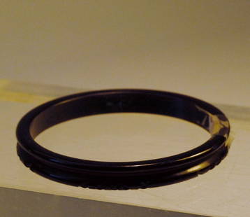 Brown Slim Bakelite Bangle with carved "x" Design: Brown colored bakelite bangle with a slim design and with carved center line and "x" design