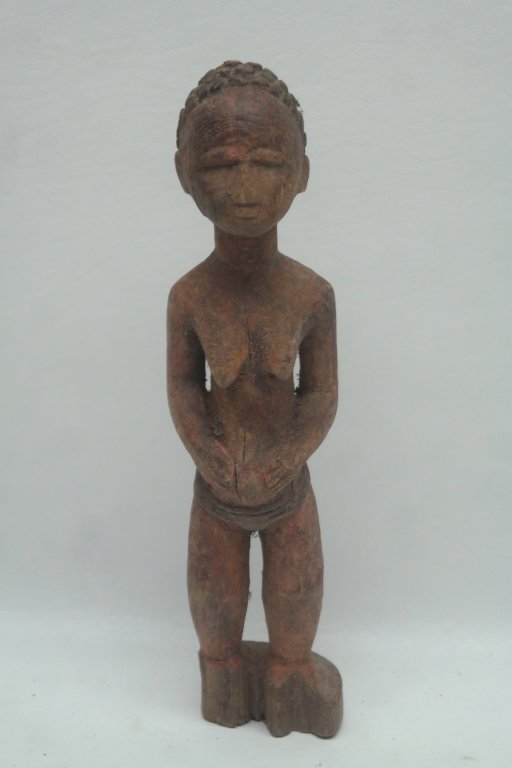 Antique African Carved Wooden Figure: Carved African figure in female form and having red paint.