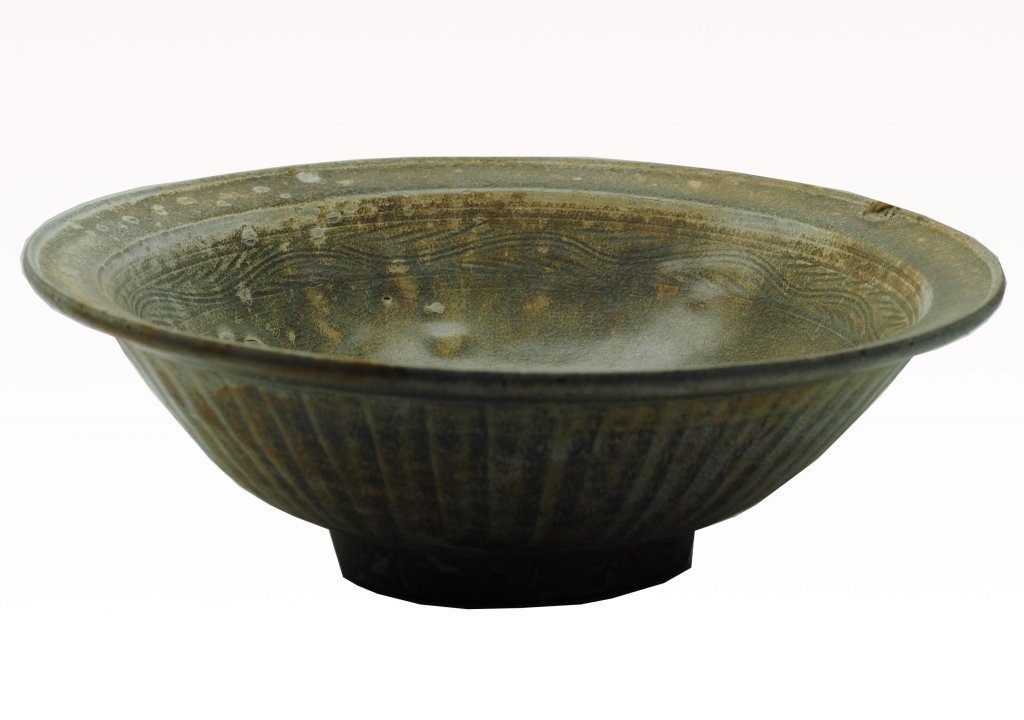 Antique 15th/16th C Thai Celadon Bowl: Antique Thai Celadon bowl having footed base and striated design to exterior. Interior having band consisting of a scrolling motif. Diameter: 11.5 in Height: 4 in Condition: Having bubbles to glaze an