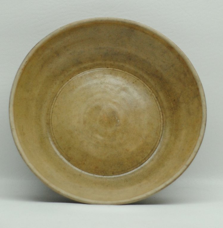Antique Thai Celadon Dish: Antique Thai celadon dish having evidence of light green glazing. Also having burnt umber color to exterior. Diameter: 10.5 in