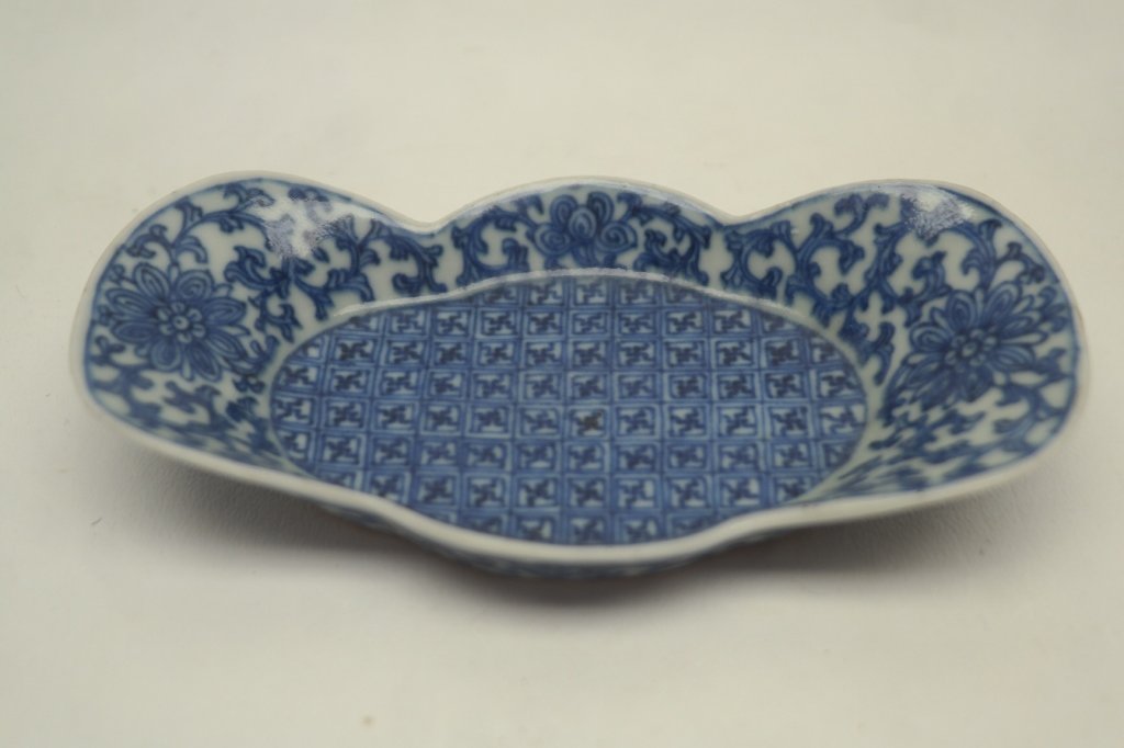 Late 18th century Shaped Dish 'Signed': Antique blue and white porcelain dish having scalloped edge. Also having lotus blossom motif and Buddhist swastikas. Base is marked. Width: 5.5 in