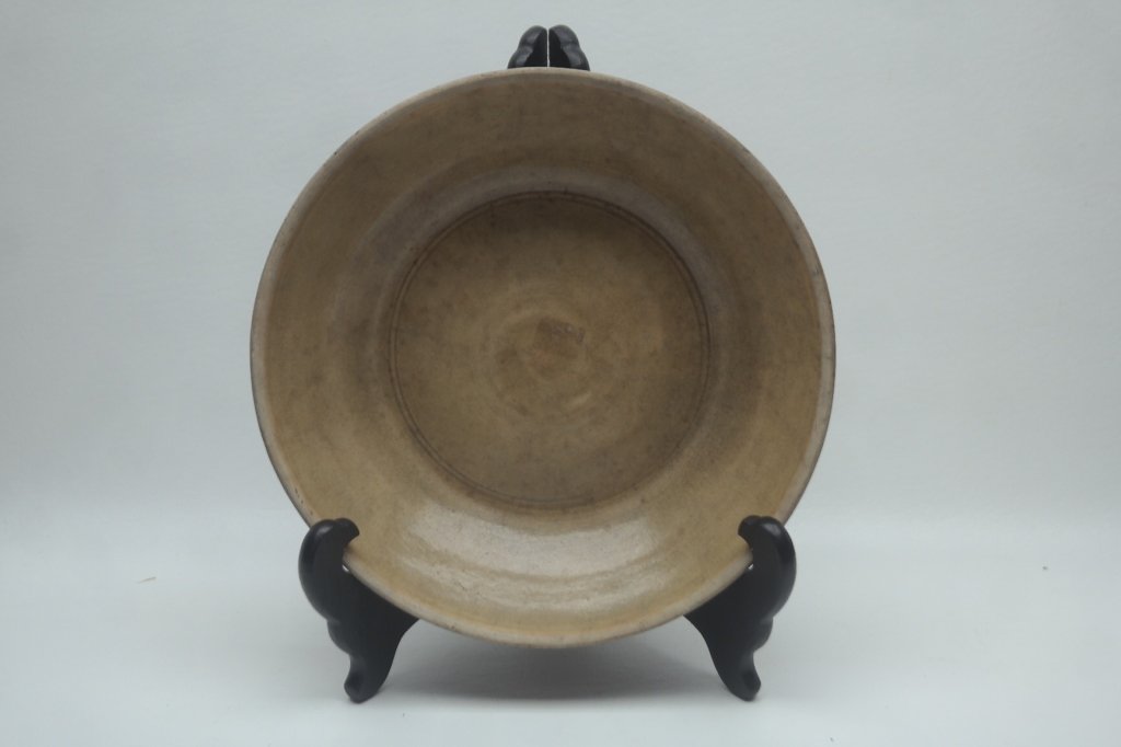 Antique Thai Dish: Antique Thai Dish having footed base and having brown glazing. Diameter: 10 in. Height: 2.5 in