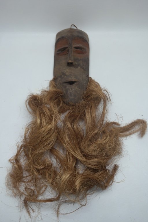 Antique African Lega Tribe Mask: Antique Lega mask from the Congo. In wood construction and having original red paint around almond shaped eyes. With husk beard tied to mask.