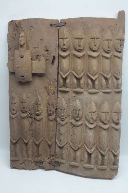 Antique West African Dogon Granary Door: Antique West African Dogon Granary door in wood construction. Having two rows of Nommo figures. Lock is also comprised of Nommo figure. Height: 21 inches. Width: 15 inches
