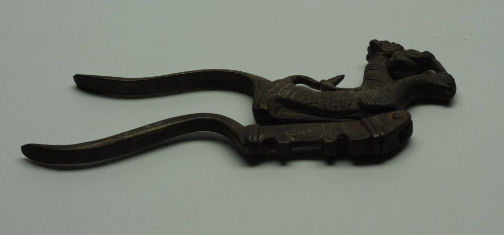 Antique Indonesian Betel Nut Cutter: Antique Indonesian Betel Nut Cutter in metal construction having form of stylized animal. Betel nuts are a popular ceremonial practice of Oceania and Southern Asia. The betel nut is comprised of the a