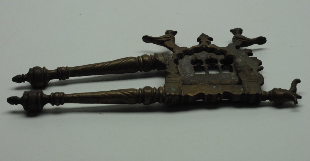 Antique Indonesian Betel Nut Cutter: Antique Indonesian betel nut cutter in metal construction and having imagery of stylized birds and an elephant head. The betel nut has been a part of ceremonial practices in Southern Asian and Oceania