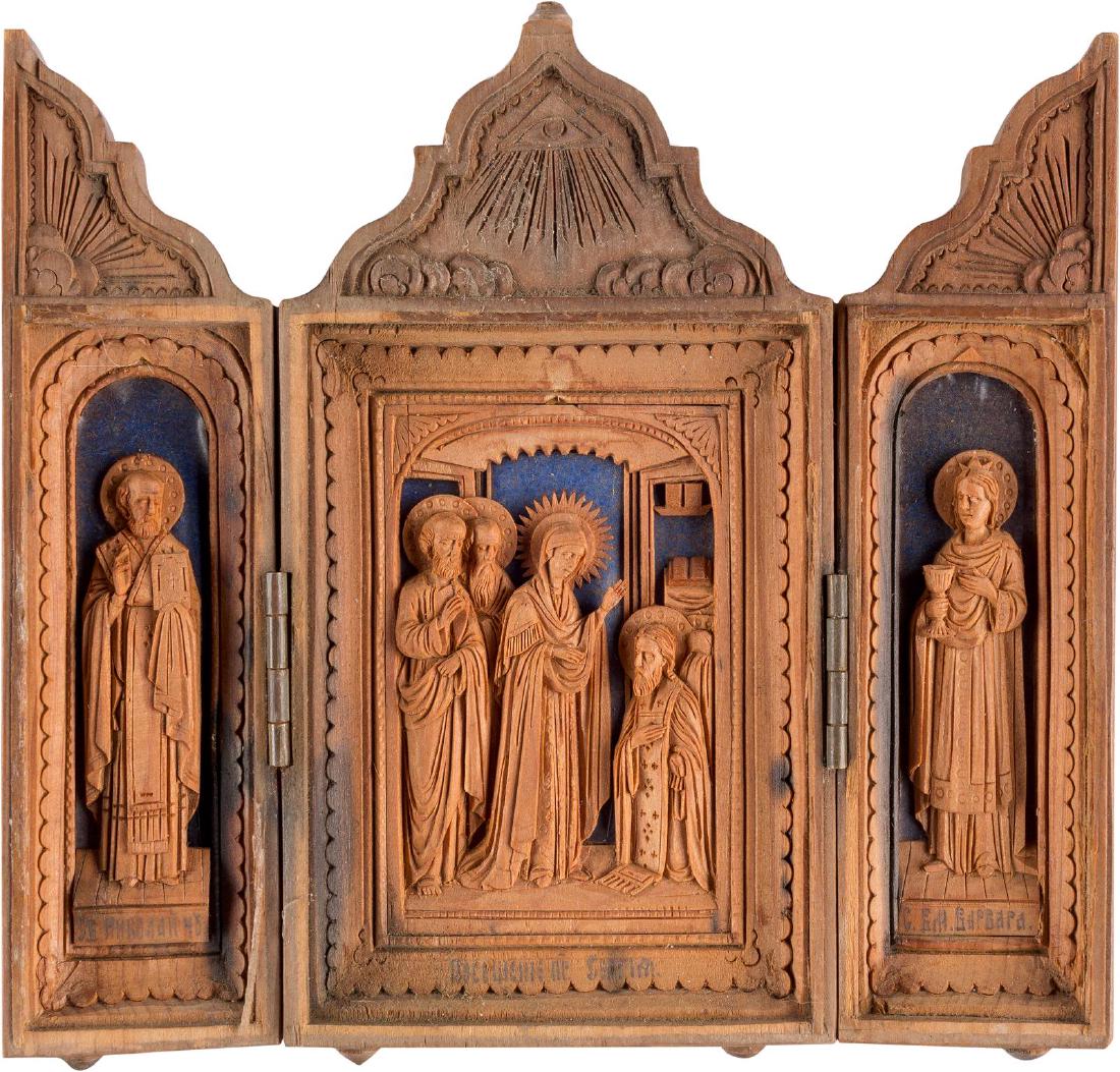 A SMALL CARVED WOOD TRIPTYCH SHOWING THE APPEARANCE OF: A SMALL CARVED WOOD TRIPTYCH SHOWING THE APPEARANCE OF THE MOTHER OF GOD TO ST. SERGEI OF RADONEZH Russian, late 19th century Finely carved in relief. The wings showing Sts. Nicholas of Myra and Barba