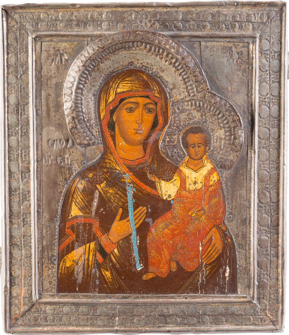 AN ICON SHOWING THE SMOLENSKAYA MOTHER OF GOD WITH RIZA: AN ICON SHOWING THE SMOLENSKAYA MOTHER OF GOD WITH RIZA Russian, late 19th century Tempera on wood panel. Overlaid with a metal riza. Minor losses, traces of corrosion. 31 x 26.8 cm.IKONE MIT DER GOTT