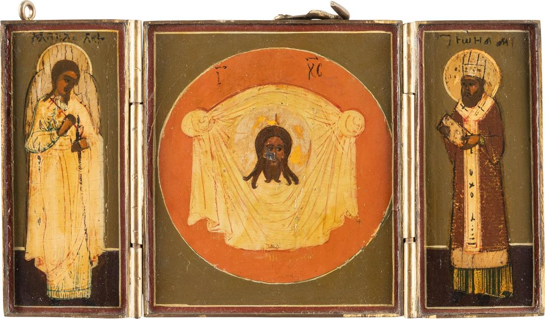 A TRIPTYCH SHOWING THE MANDYLION, THE GUARDIAN ANGEL: A TRIPTYCH SHOWING THE MANDYLION, THE GUARDIAN ANGEL AND ST. JOHN CHRYSOSTOM Russian, 19th century Tempera on wood panel. The haloes gilded. Brass mount. Minor losses. 8 x 14.4 cm. TRIPTYCHON MIT DEM 
