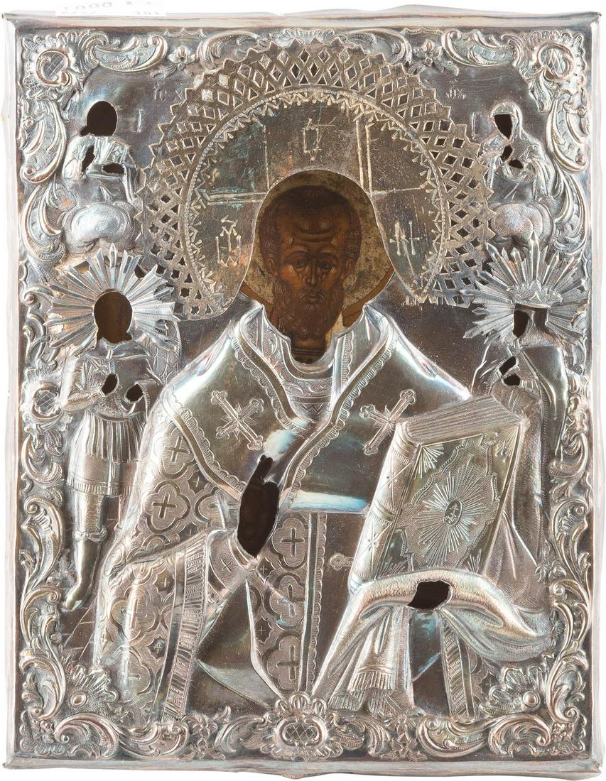 A SMALL ICON SHOWING ST. NICHOLAS OF MYRA WITH A SILVER: A SMALL ICON SHOWING ST. NICHOLAS OF MYRA WITH A SILVER OKLAD Russian, 19th century (icon), Russian, Astrakhan, 1860 (oklad) Tempera on wood panel with kovcheg. The halo made of silver. Overlaid with 