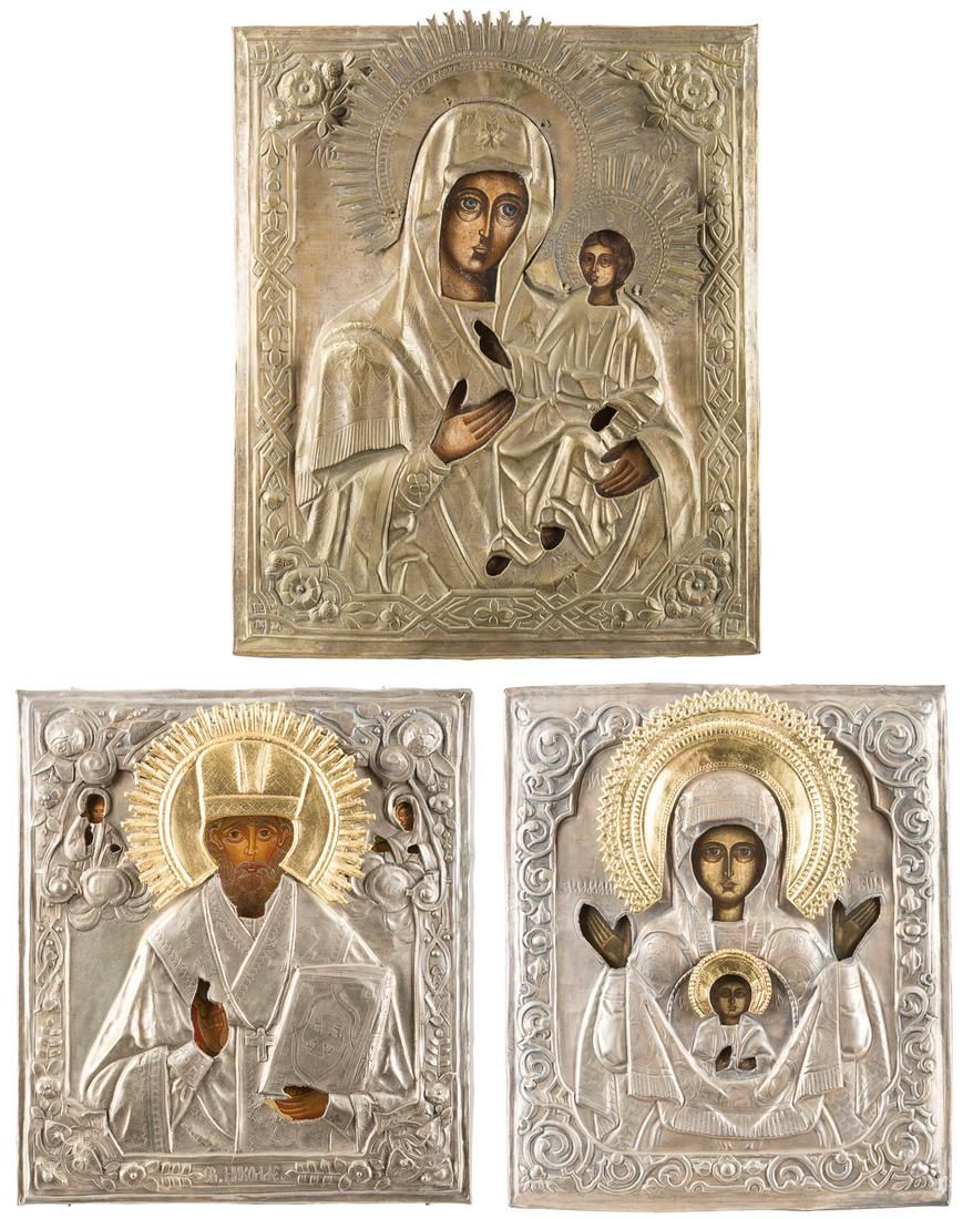 THREE ICON WITH OKLAD SHOWING IMAGES OF THE MOTHER OF: THREE ICON WITH OKLAD SHOWING IMAGES OF THE MOTHER OF GOD AND ST. NICHOLAS OF MYRA Russian, 19th/20th century Oil on wood panels. Overlaid with metal oklads. 30.8-38 cm high. DREI IKONEN MIT OKLAD: GN