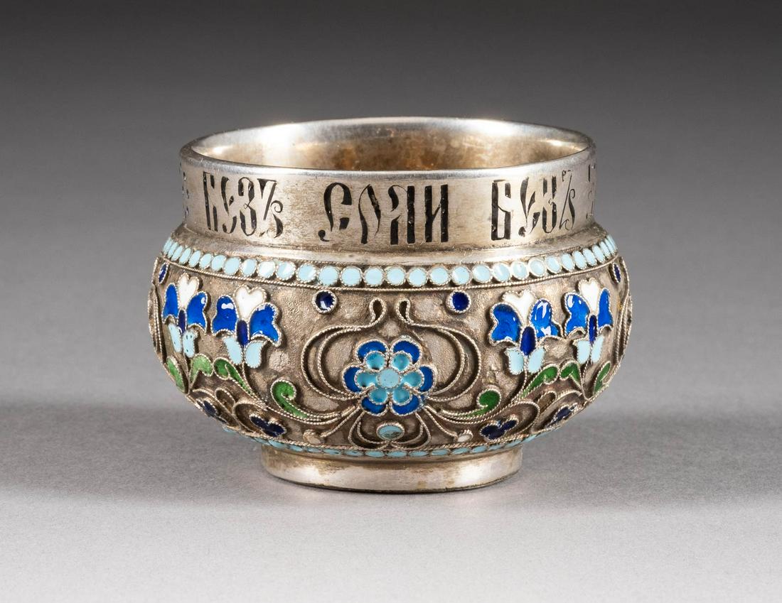 A SILVER AND CHAMPLEVÉ AND CLOISONNÉ ENAMEL SALT 2nd: A SILVER AND CHAMPLEVÉ AND CLOISONNÉ ENAMEL SALT 2nd half 20th century The body decorated with stylized foliage. Bearing spurious Russian hallmarks. Diam. 6.3 cm, 163 gr. CHAMPLEVÉ- UND CLOISONNÉ-