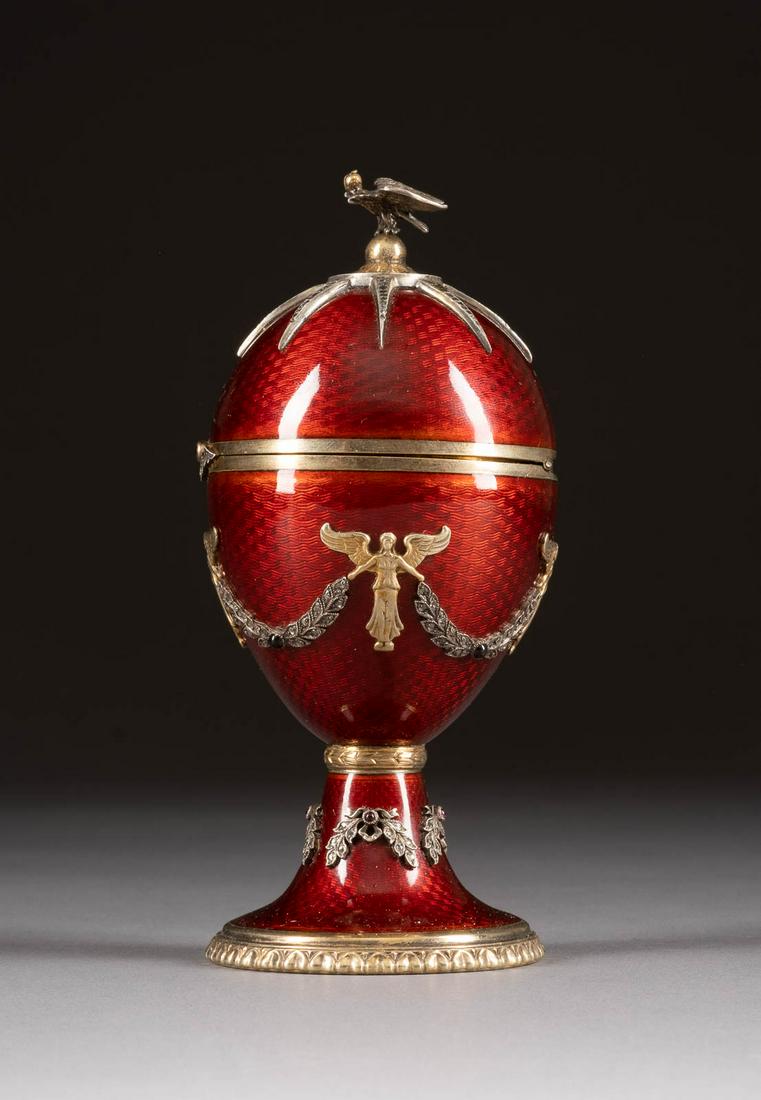 A SILVER-GILT AND GUILLOCHÉ ENAMEL EGG SHAPED BOX 2nd: A SILVER-GILT AND GUILLOCHÉ ENAMEL EGG SHAPED BOX 2nd half 20th century The body set with rose-cut diamonds. Bearing spurious Russian hallmarks. Within a fitted wooden case. 13.8 cm high. GUILLOCHÉ-
