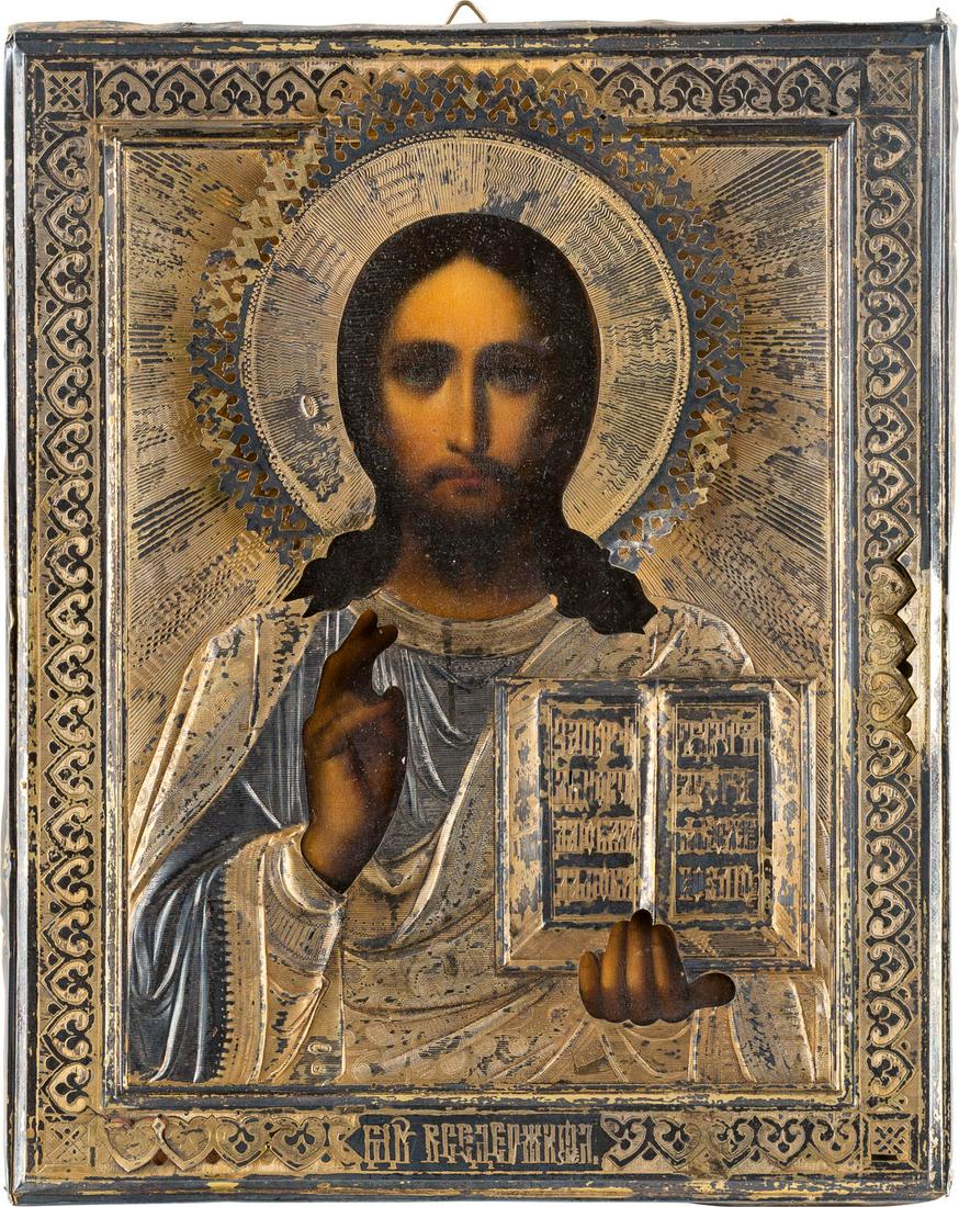 A SMALL ICON SHOWING CHRIST PANTOKRATOR WITH A: A SMALL ICON SHOWING CHRIST PANTOKRATOR WITH A SILVER-GILT OKLAD Russian, early 20th century (icon), Russian, Moscow, 1908-1917 (oklad) Oil on wood panel with velvet backing. Overlaid with an engraved