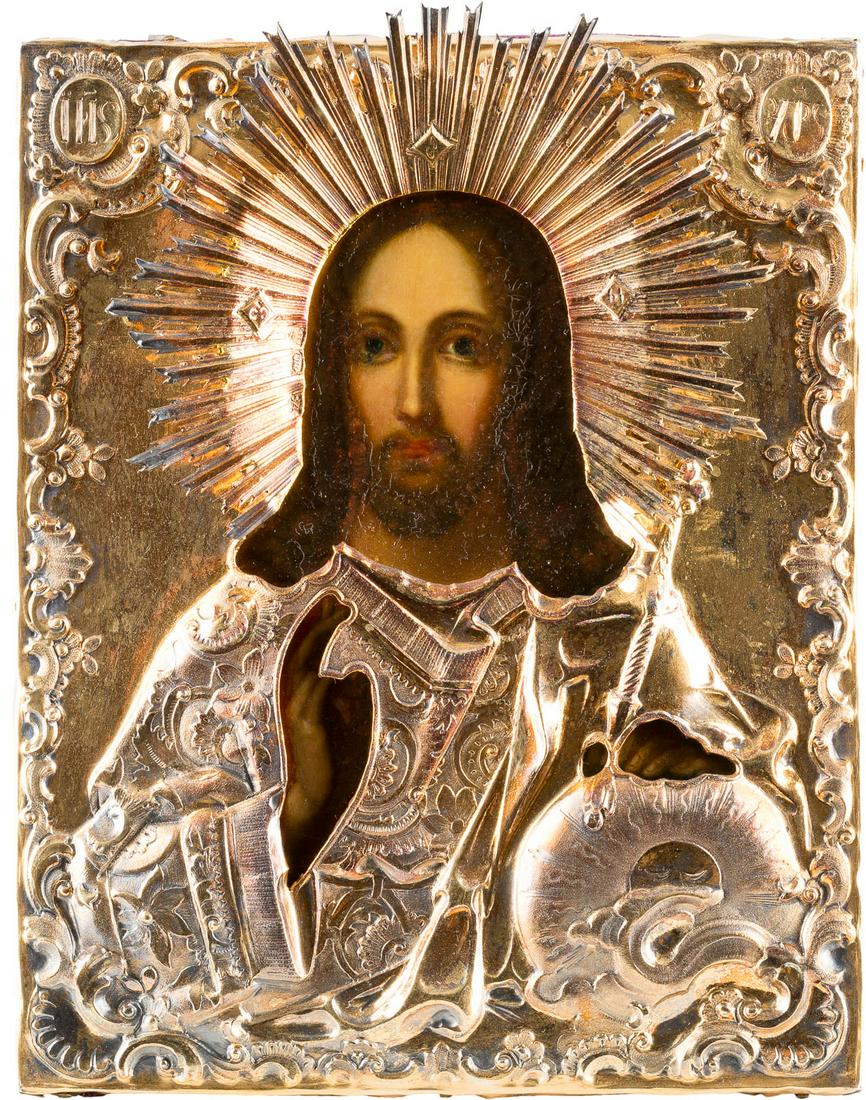 A SMALL ICON SHOWING CHRIST THE SAVIOUR WITH A: A SMALL ICON SHOWING CHRIST THE SAVIOUR WITH A SILVER-GILT OKLAD Russian, mid 19th century (icon), Russian, Moscow, 1850 (oklad) Oil on wood panel. Overlaid with a chased and embossed silver-gilt okla