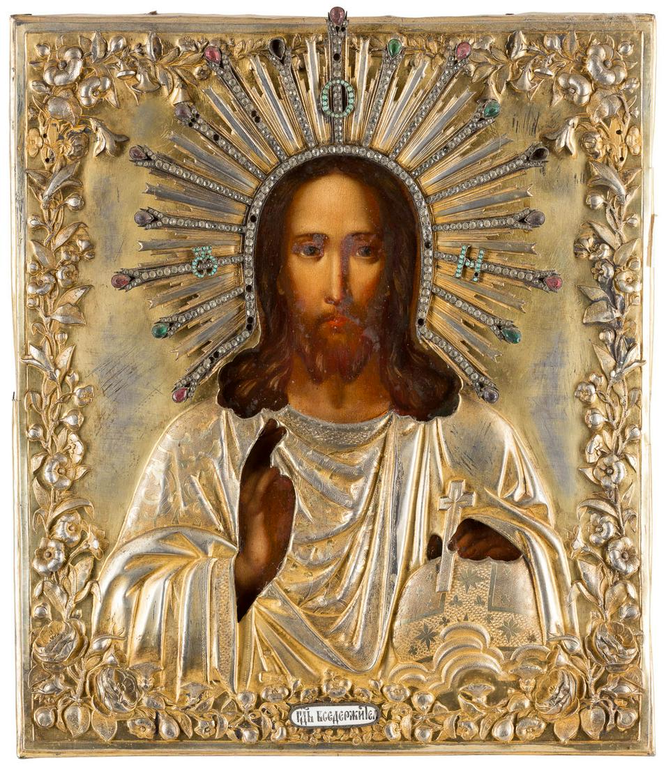 AN ICON SHOWING CHRIST PANTOKRATOR WITH A SILVER-GILT: AN ICON SHOWING CHRIST PANTOKRATOR WITH A SILVER-GILT OKLAD Russian, mid 19th century (icon), Russian, Moscow, 1867 (oklad) Oil on wood panel. The silver-gilt oklad with elaborate embossed foliate rep