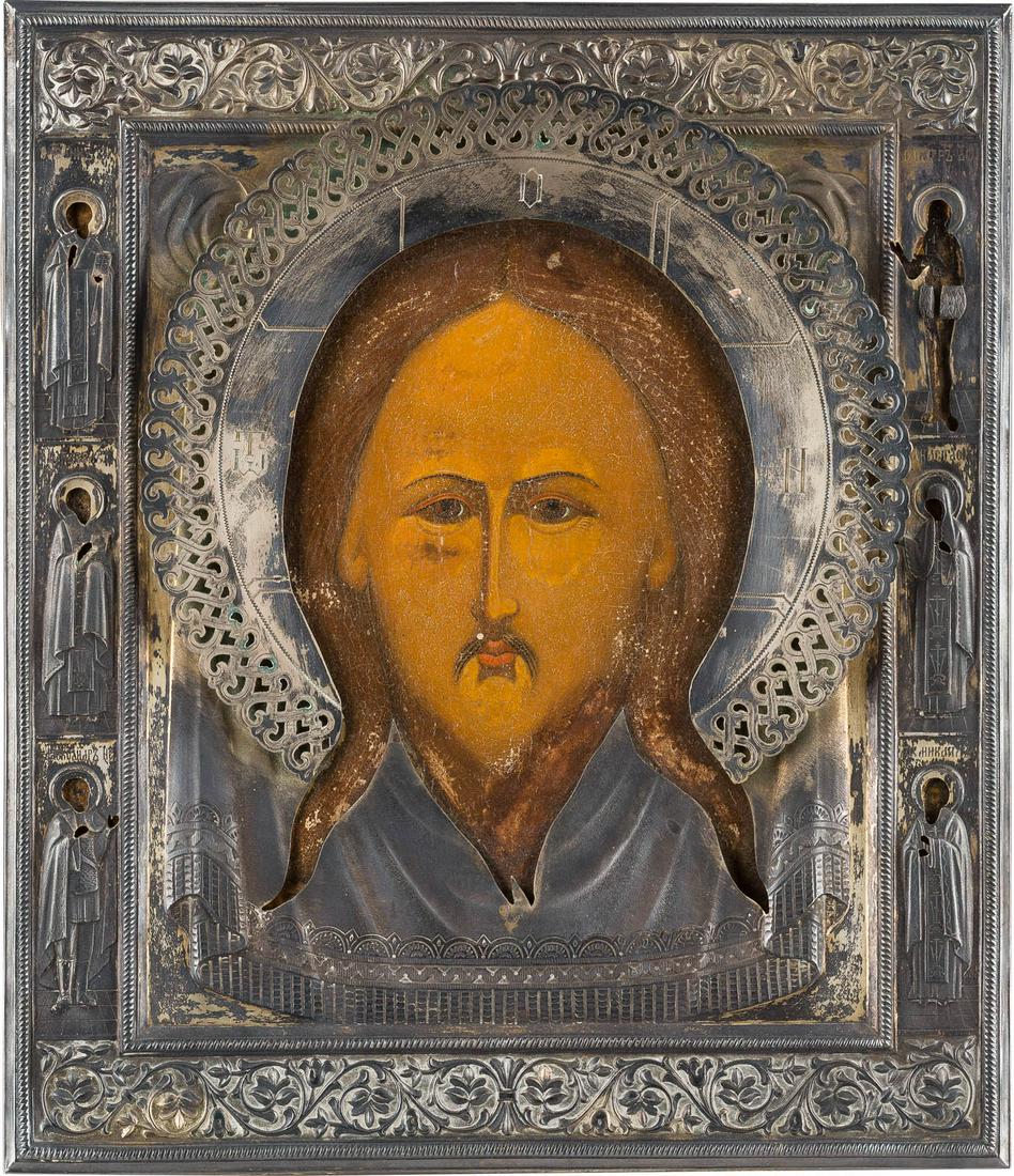 AN ICON SHOWING THE MANDYLION WITH A SILVER OKLAD: AN ICON SHOWING THE MANDYLION WITH A SILVER OKLAD Russian, 18th century (icon), Russian, St. Petersburg, 1896-1908 (oklad) Tempera on wood panel with kovcheg and velvet backing. Six selected saints on