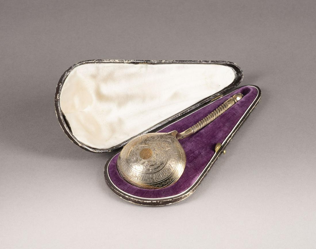 A LARGE SILVER-GILT SPOON WITHIN ORIGINAL FITTED CASE: A LARGE SILVER-GILT SPOON WITHIN ORIGINAL FITTED CASE Russian, Moscow, 1859 With rounded bowl and part-twist handle, with engraved geometric and foliate designs on the exterior. Marked on handle with 