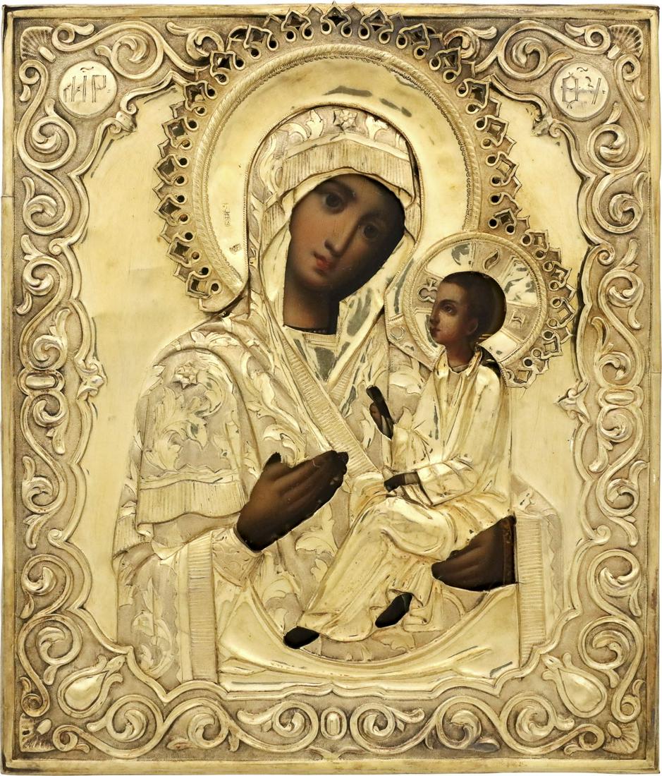 AN ICON SHOWING THE TIKHVINSKAYA MOTHER OF GOD WITH A: * AN ICON SHOWING THE TIKHVINSKAYA MOTHER OF GOD WITH A SILVER-GILT OKLAD Russian, mid 19th century (icon), Russian, Moscow, 1857 (oklad) Tempera on wood panel. Overlaid with a chased and embossed sil
