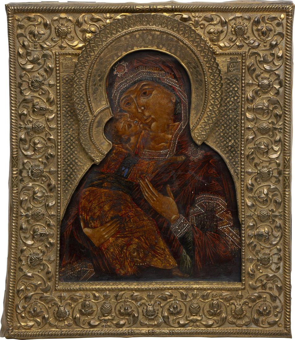 AN ICON SHOWING THE VLADIMIRSKAYA MOTHER OF GOD WITH: AN ICON SHOWING THE VLADIMIRSKAYA MOTHER OF GOD WITH RIZA Russian, 19th century (riza) Tempera on wood panel with kovcheg. Overlaid with a chased brass riza decorated with foliage. The icon painted in