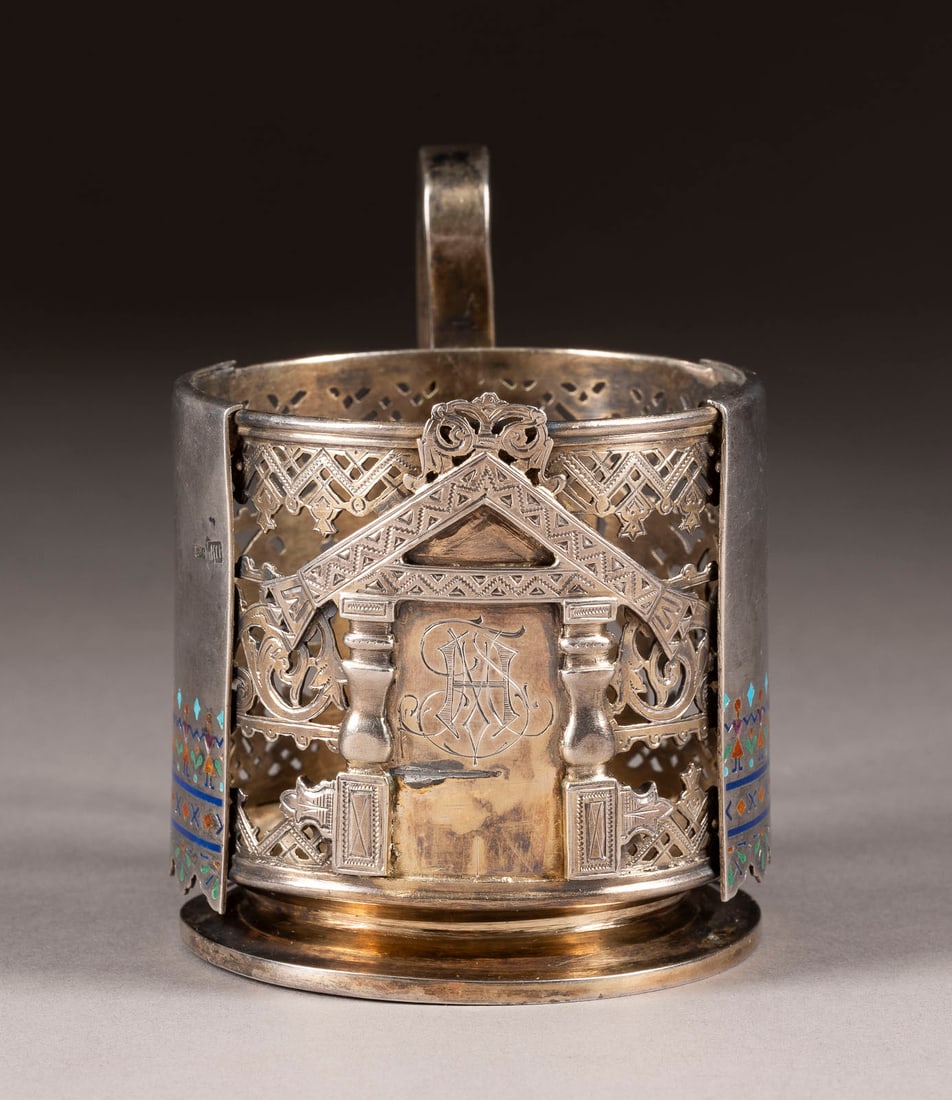 A PARCEL-GILT CHAMPLEVE ENAMEL SILVER TEA GLASS HOLDER: A PARCEL-GILT CHAMPLEVE ENAMEL SILVER TEA GLASS HOLDER Russian, Moscow, Mikhael Dimitrievitch Paramonov, 1891 Cylindrical, the body repousse and chased with architectural motifs. Enamelled with varico