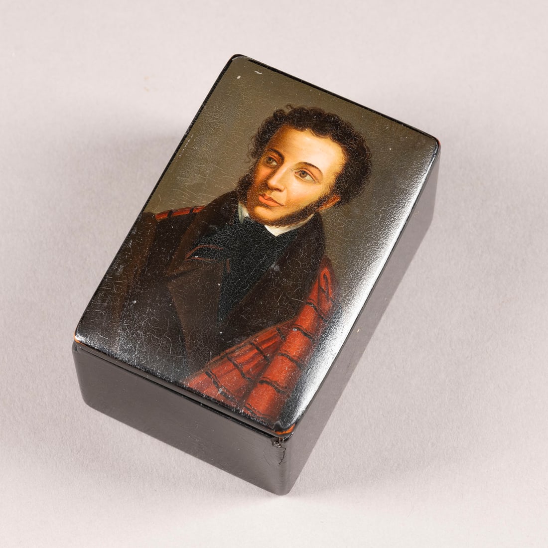 A PAPIER-MACHE AND LACQUER BOX WITH THE PORTRAIT OF ALEXANDER PUSHKIN: A PAPIER-MACHE AND LACQUER BOX WITH THE PORTRAIT OF ALEXANDER PUSHKIN Russian, Danilkovo, Pjotr and Aleksandr Lukutin, 1843-1855 Of rectangular form. The hinged cover painted with a portrait. The inte