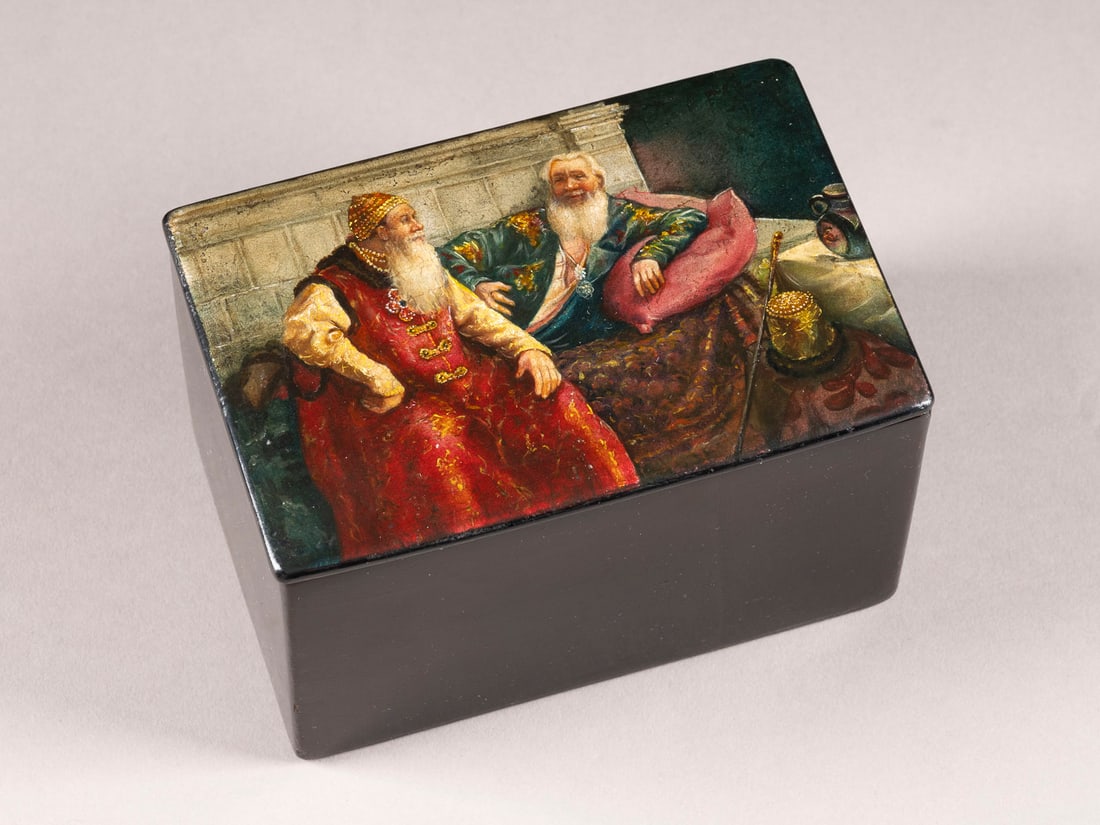 A PAPIER-MACHE AND LACQUER BOX WITH TWO OLD MEN AFTER KLAVDY VASILIYEVICH LEBEDEV: A PAPIER-MACHE AND LACQUER BOX WITH TWO OLD MEN AFTER KLAVDY VASILIYEVICH LEBEDEV Russian, Ostashkovo, Vishnyakov Factory, 1882-1885 Of rectangular form. The hinged cover finely painted on black groun