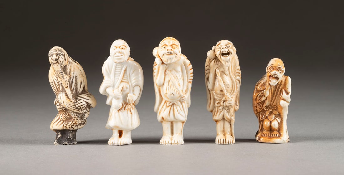 FIVE PORZELLAN NETSUKE OF SENNIN: FIVE PORZELLAN NETSUKE OF SENNIN Japan, 19th century or later Ceramic. H. 5.5-6.8 cm. Including 5 figures of Sennin holding their respective symbolic item. With traces of use, partially damaged. halte