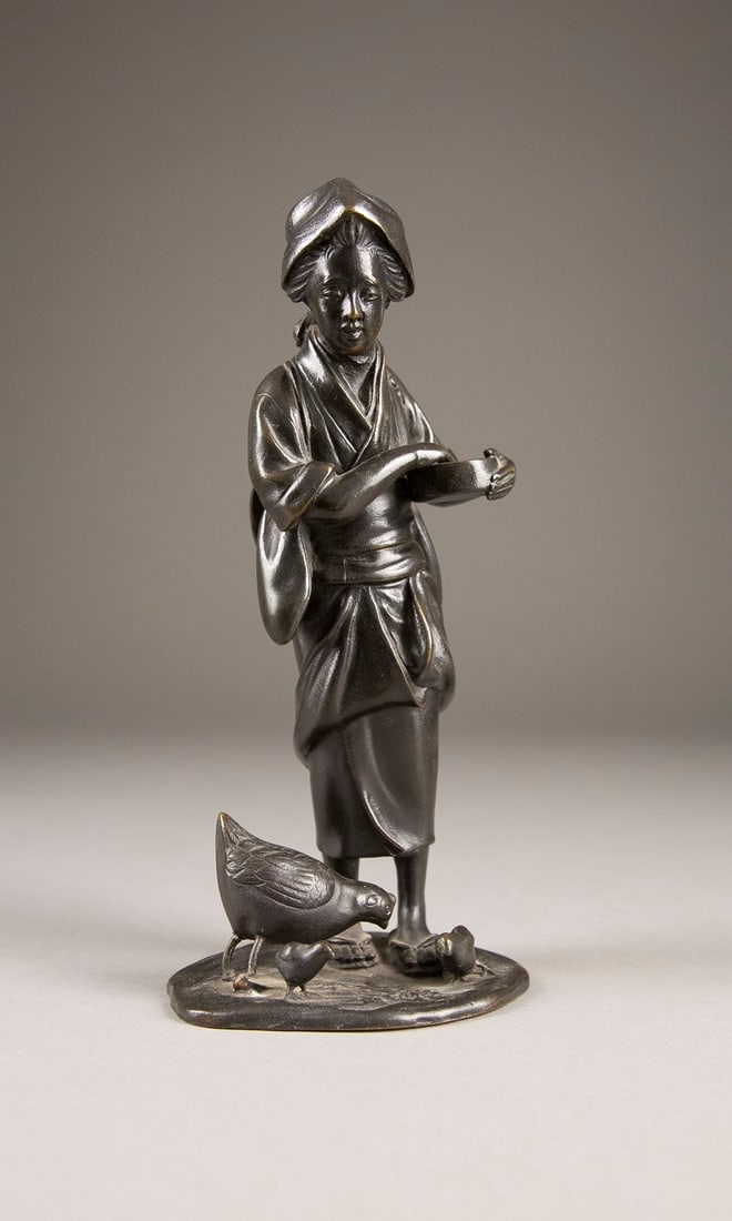 A JAPANESE BRONZE FIGURINE OF A LADY FEEDING CHICKEN Japan, Meiji-Era Partially rubbed. Verso signed (1 of 4)