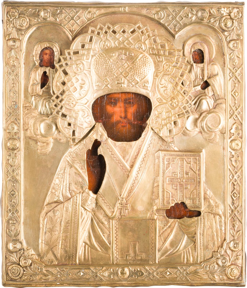 IKONE MIT DEM HEILIGEN NIKOLAUS VON MYRA MIT OKLAD: AN ICON SHOWING ST. NICHOLAS OF MYRA WITH OKLAD Russian, circa 1860 Oil on wood panel with cloth backing. Overlaid with a chased brass oklad. Minor losses. 31.5 x 27.3 cm.IKONE MIT DEM HEILIGEN NIKOLA
