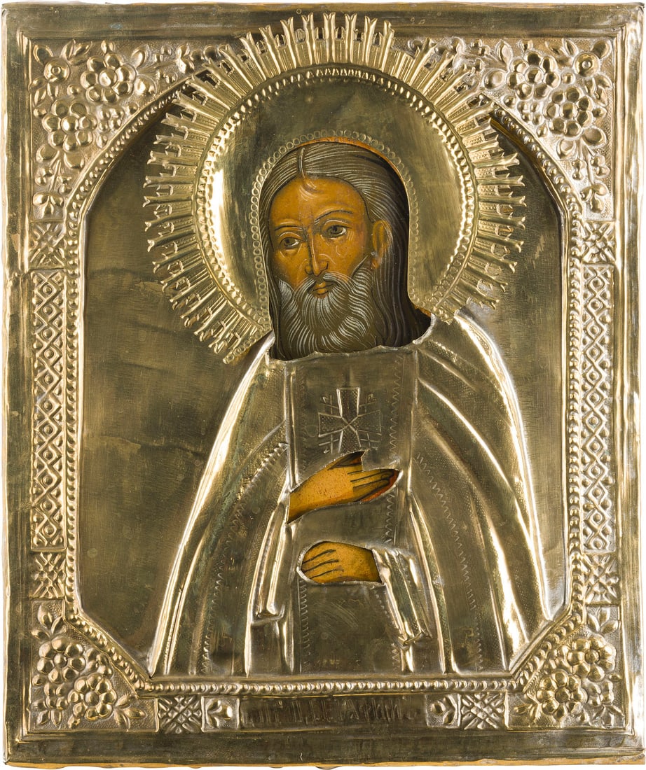 IKONE MIT DEM HEILIGEN SERAFIM VON SAROW MIT OKLAD: AN ICON SHOWING ST. SERAFIM OF SAROV WITH OKLAD Russian, after 1903 Tempera on wood panel. Overlaid with a chased brass oklad. Minimally restored. 31.2 x 26.2 cm.IKONE MIT DEM HEILIGEN SERAFIM VON SAR