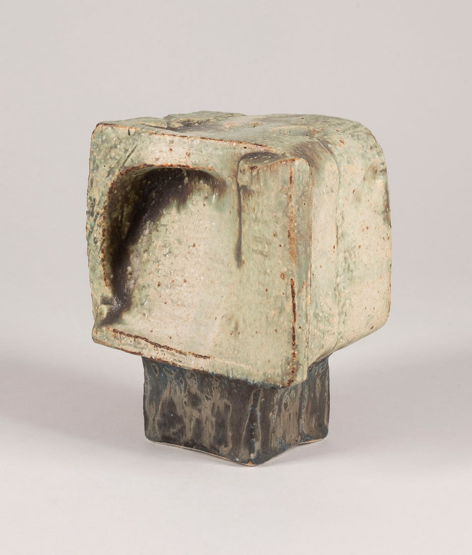 ROBERT STURM - QUADERVASE: ROBERT STURM 1935 Bad Elster - 1994 Fulda QUADERVASE 1973 Pale clay, sculpted, form composed of blocks and plates, transparent light-green and brown glaze, thick multi-tone olive green at the base. H.