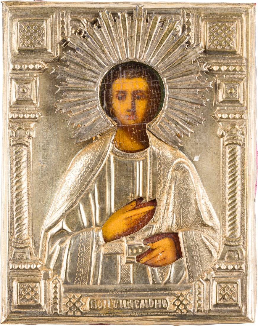 A SMALL ICON SHOWING ST. PANTELEIMON WITH OKLAD: A SMALL ICON SHOWING ST. PANTELEIMON WITH OKLAD Russian, 19th century Oil on wood panel with cloth backing. Overlaid with a chased brass oklad. 22 x 17.5 cm. KLEINE IKONE MIT DEM HEILIGEN PANTELEIMON 