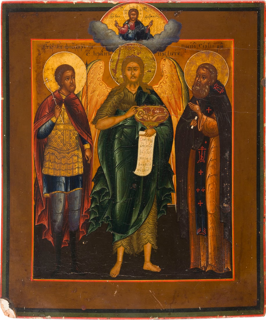 A SMALL ICON SHOWING ST. JOHN THE FORERUNNER FLANKED BY STS. THEODORE AND SERGEY OF: A SMALL ICON SHOWING ST. JOHN THE FORERUNNER FLANKED BY STS. THEODORE AND SERGEY OF RADONEZH Russian, 19th century Tempera on wood panel with kovcheg. The haloes made of gold. The edges minimally chip