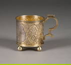 A VERY FINE SILVER AND PARCEL-GILT TEA GLASS HOLDER 'THE SURPRISE'
