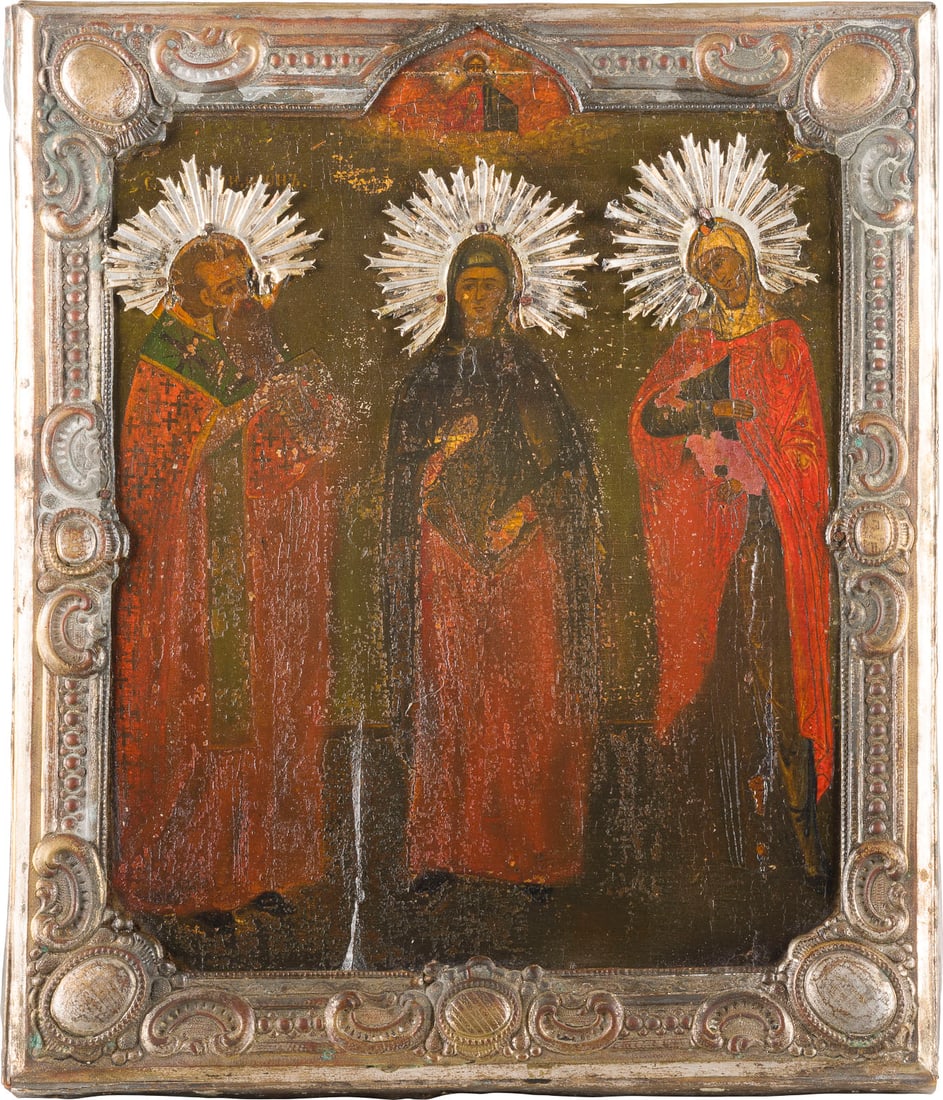AN ICON SHOWING STS. SIMEON, ANNE AND MAFRA WITH BASMA: AN ICON SHOWING STS. SIMEON, ANNE AND MAFRA WITH BASMA Russian, mid-19th century Oil on gessoed wood panel, with a brass basma. Paint rising, restorations, edges partly replaced. 31.8 x 26.5 cm. IKONE