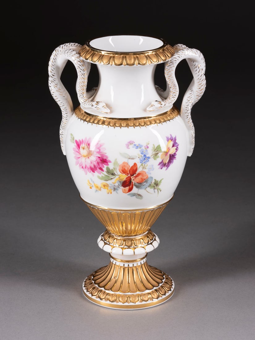 | SCHLANGENHENKELVASE MIT BLUMENMALEREI: SCHLANGENHENKELVASE MIT BLUMENMALEREI Deutsch, Meissen, 1850-1924 Porzellan, polychrome Malerei, glänzende und matte Goldstaffage. H. 27,3 cm. Unterglasurblaue Knaufschwerter, Mallernr. Modellnr. 'E1