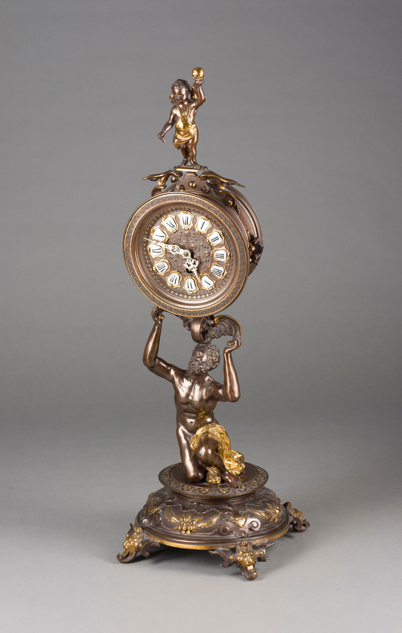 | SELTENE FIGURENUHR 'TEMPUS FUGIT': SELTENE FIGURENUHR 'TEMPUS FUGIT' Deutsch, Freiburg, Gustav Becker, um 1885 Metallguss, part. vergoldet, Metall, Email. Stahl. Ca. 68 x 22 x 22 cm. Auf dem Werk bez. 'Gustav Becker Freiburg',