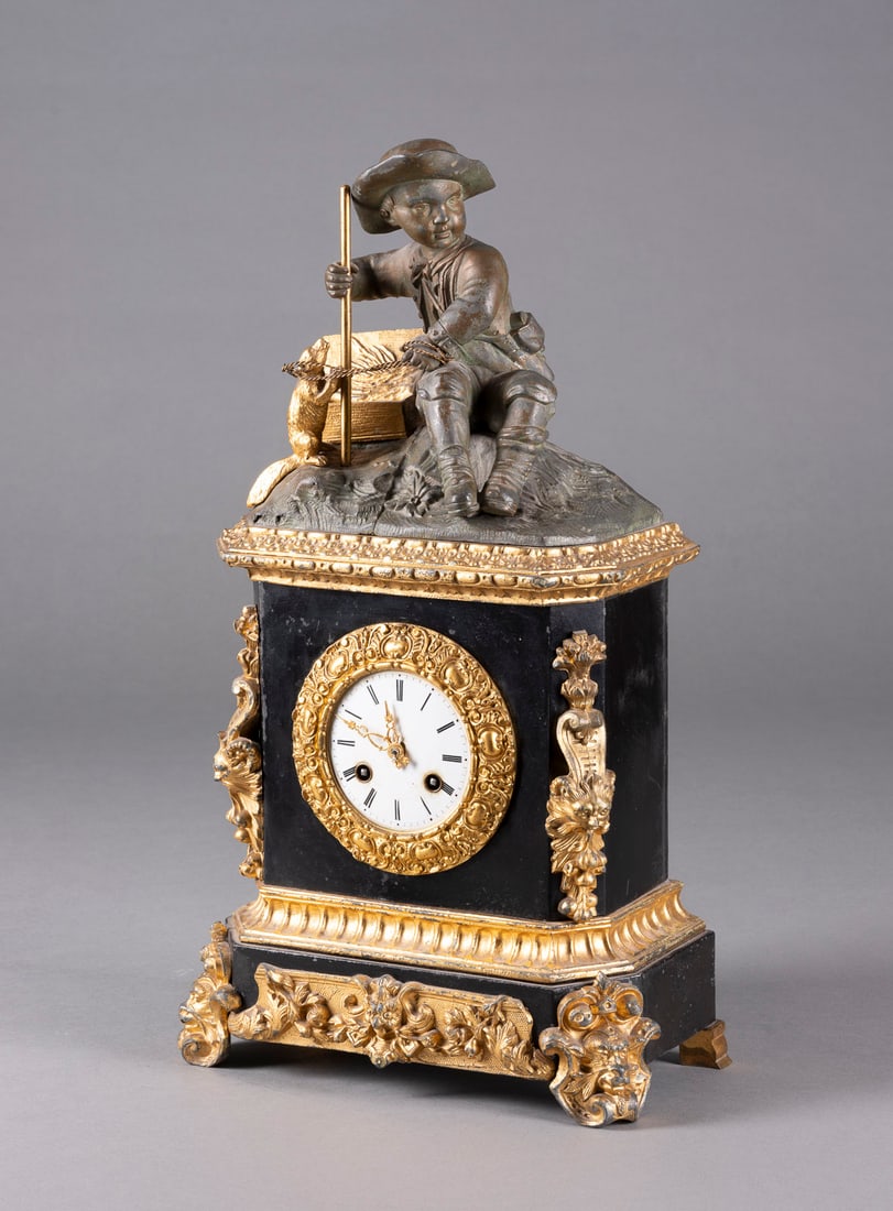 | FIGURENPENDULE 'JUNGE MIT BIBER': FIGURENPENDULE 'JUNGE MIT BIBER' Frankreich, 1. Viertel 19. Jh. Metallguss, brüniert bzw. gold gefasst, Email, Metall, Stahl. 48 x 26 x 14 cm. Auf dem Werk bez. 'Douillon A St. Nicolas'.